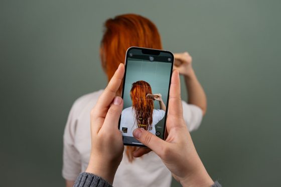 Personne prenant une photo de profil avec son smartphone pour Tinder
